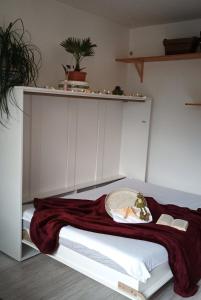 a bedroom with a white bed with a shelf at Appartement Sternblick in Bad Reichenhall