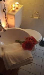 a bathroom with a sink and a toilet with a flower on it at Appartement Sternblick in Bad Reichenhall