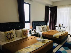 Postelja oz. postelje v sobi nastanitve D'Gunduls Homestay STUDIO by DGH I-CITY