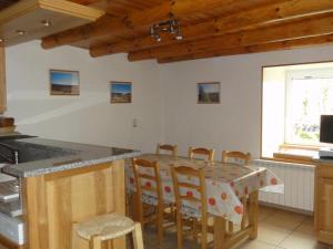 een keuken met een tafel en stoelen in een kamer bij Holiday in a gite in Lozre in a pretty corner of Margeride in Mialanes