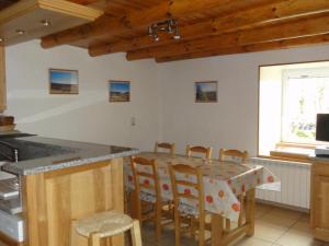 a kitchen with a table and chairs in a room at Holiday cottage in Lozre in a pretty corner of Margeride in Mialanes