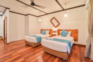 Postel nebo postele na pokoji v ubytování Borneo Divers Mabul Resort