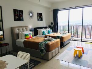 Postelja oz. postelje v sobi nastanitve D'Gunduls Homestay STUDIO by DGH I-CITY