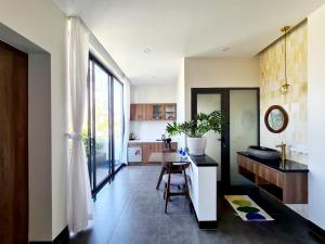 a kitchen with a table and a dining room at MyFa House in Hue