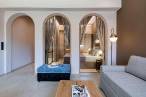 a living room with a couch and a bedroom at Muse Urban Suites in Athens