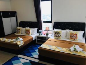Postelja oz. postelje v sobi nastanitve D'Gunduls Homestay STUDIO by DGH I-CITY