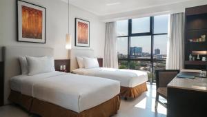 Rúm í herbergi á The B Hotel Alabang