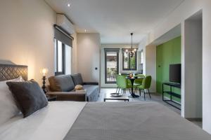 a bedroom with a bed and a living room at Muse Urban Suites in Athens
