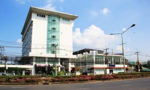 a large white building on the side of a street at V Verve Service Apartment Hotel in Chachoengsao