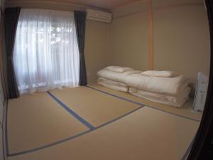 a room with two beds sitting on the floor at Machiya Kyoto Shogoin in Kyoto