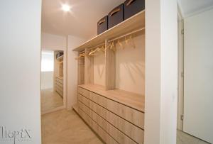 a walk in closet with wood paneling and shelves at Splendeur Sur La Mer - One Bedroom in Airlie Beach