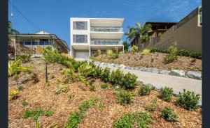 a row of plants in front of a building at Splendeur Sur La Mer - Two Bedroom in Cannonvale