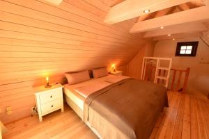 a bedroom with a bed in a wooden room at Wiekhaus 49 in Neubrandenburg