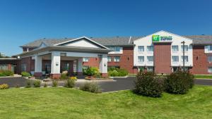 un bâtiment d'hôtel avec une pelouse devant lui dans l'établissement Holiday Inn Express Quebec City-Sainte Foy, an IHG Hotel, à Québec