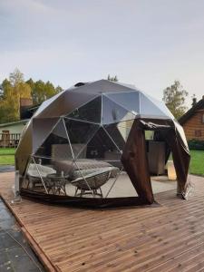 a tent on top of a wooden deck at kupolas in Šiauliai