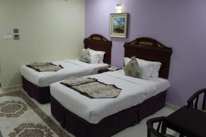 Rúm í herbergi á Al Diyar Hotel