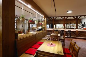 a restaurant with tables and chairs and a bar at Šindlovská krčma in České Budějovice