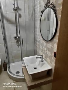 a bathroom with a sink and a shower and a mirror at Appartamento Suite Santa Teresa in Taranto