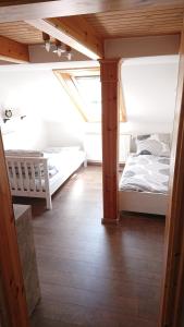 a attic bedroom with two beds and a skylight at Ferienwohnung Zum Steinberg in Bredstedt