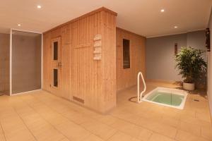 a bathroom with a bath tub in a room at Waldhotel Berghof in Luisenthal