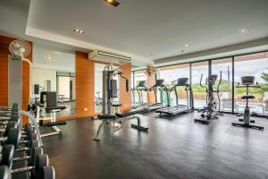 a gym with a bunch of treadmills and ellipticals at CA Hotel and Residence Phuket - SHA Extra Plus in Phuket Town