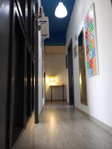 a hallway in a building with a painting on the wall at Idria B&B in Barcellona-Pozzo di Gotto