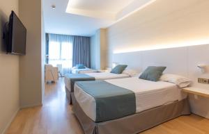 Posteľ alebo postele v izbe v ubytovaní Hotel Olympia Valencia