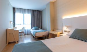 Posteľ alebo postele v izbe v ubytovaní Hotel Olympia Valencia