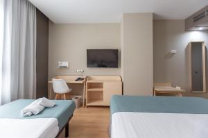 Posteľ alebo postele v izbe v ubytovaní Hotel Olympia Valencia