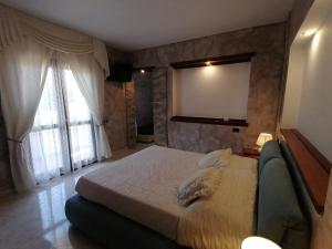 a bedroom with a large bed and a large window at Sardinia B&B house in Olbia