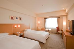 Кровать или кровати в номере Hotel Hewitt Koshien