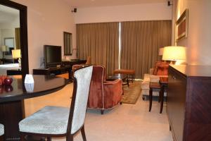 a living room filled with furniture and a tv at Oakwood Premier Prestige Bangalore in Bangalore