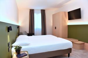 Postel nebo postele na pokoji v ubytování Hotel Casa Del Pellegrino