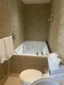 a white bath tub sitting next to a white toilet at 30 James Street in Liverpool