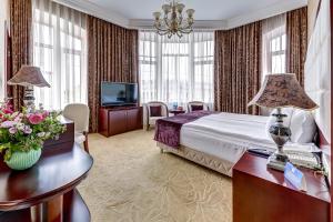 a hotel room with a bed and a television at Akyan St.Petersburg in Saint Petersburg
