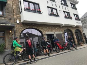 a group of people standing outside of a building at PANACHE - BIKE EN SLEEP HOTEL in La Roche-en-Ardenne