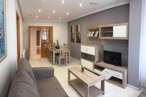 a living room with a couch and a table at Vivienda en 1ª Linea de Playa Rapadoira Foz in Foz