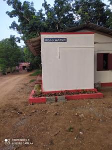 a building with a sign on the side of it at VANASIRI COTTAGE (Tourist Home) in Dharmastala