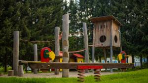 a playground with a bird house and a play structure at Camping Bella Austria in Sankt Peter am Kammersberg