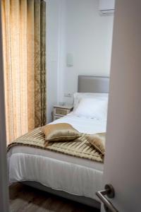 um quarto com uma cama com uma janela e uma roupa de cama. em AQUACHAVES - Apart Studios em Chaves