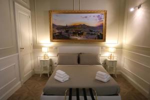 那不勒斯Vico Gelso Napoli的卧室里有一张床，墙上挂着一幅画