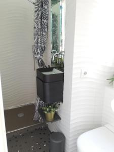 a bathroom with a black sink and a mirror at Duplex and terrace overlooking Giralda in Seville