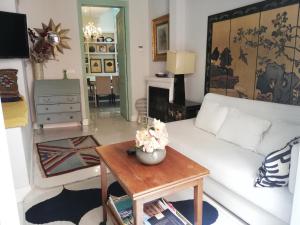 a living room with a white couch and a table at Duplex and terrace overlooking Giralda in Seville