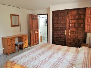 a bedroom with a bed and a wooden door at Casa Olivo in Perelló +14 photos