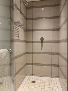 a shower with a glass door in a bathroom at The Pearls Independent Umhlanga - Durban in Durban