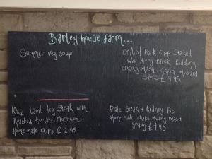 a blackboard on a brick wall with writing on it at Pendle Inn in Barrowford