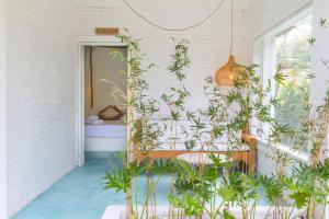 a room with lots of plants and a mirror at Guru Canggu in Canggu