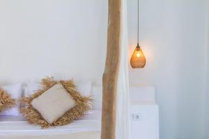 a room with a bed with a pillow and a lamp at Guru Canggu in Canggu