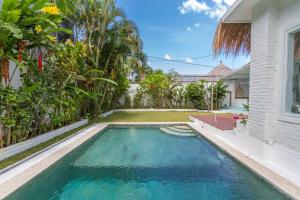 a swimming pool in the backyard of a house at Guru Canggu in Canggu