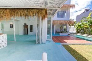 an external view of a house with a swimming pool at Guru Canggu in Canggu